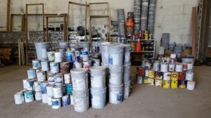 Paint Cans Stacked in Piles