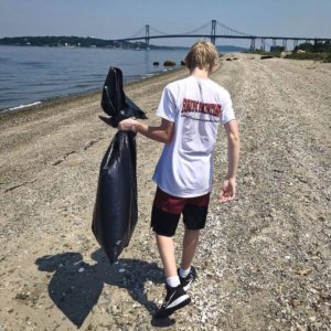 Man Picking Up Trash By Shore